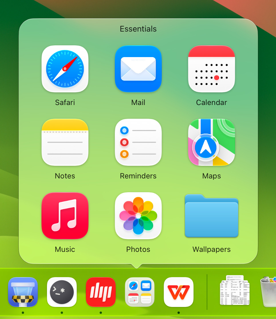 The Essentials group expanded above the Dock as a grid of apps and a Finder folder, its tail pointing at the group's tile